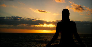 yoga on the beach at sunset